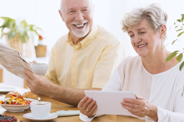 Happy senior woman with tablet