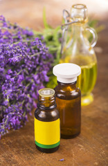 Fototapeta na wymiar lavender oil with fresh lavender on a wooden