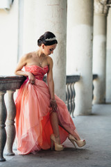 The charming girl stands on the ballcony