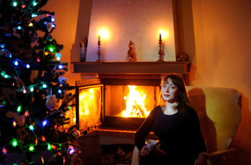 Woman relaxing by the fire place, winter weekends, cozy scene