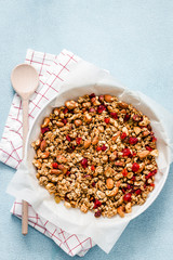 Vegan gluten free gingerbread granola on light blue background. Top view, space for text. 
