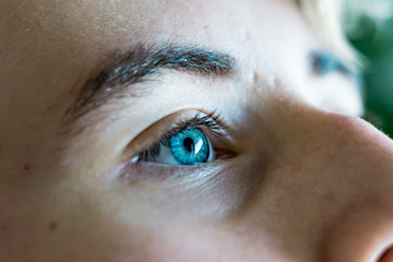 Close-up of a beautiful blue eye of a Caucasian race boy.