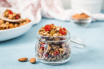 Peanut butter granola on light blue background. Selective focus, copy space.