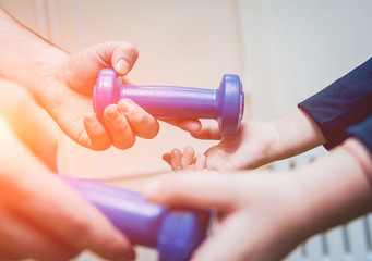 Hands with dumbbells. Sport equipment practice