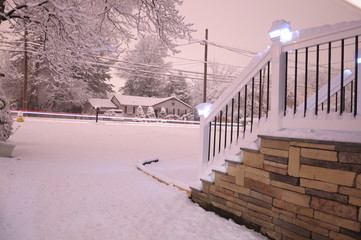 Light streak on snowy street in front of home