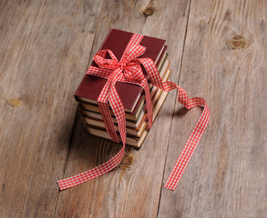 Books wrapped with color ribbon, on wooden table
