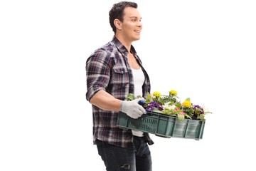 Fototapeta na wymiar Gardener holding a rack of flowers