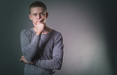 Portrait of thinking young man in the studio