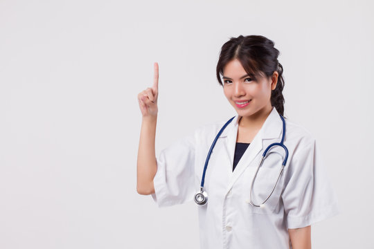 woman doctor pointing number one finger gesture, asian female health care worker or nurse point one finger to blank space