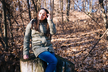 portrait of child in the forest on the background the trees in winter season