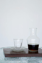 Serving coffee Hario v60 in a jug for smell, wooden. The background is blurred, all white. Side view with copy space