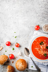 Tomato soup, Gazpacho in white bowl on grey stone background, with ingredients Top view. Copy space
