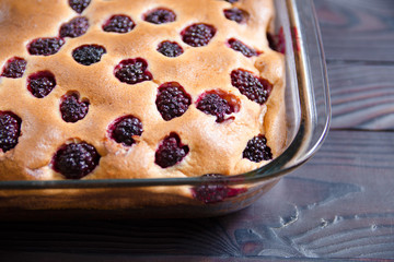 Pie with BlackBerry in a glass baking dish. Healthy home baking concept without sugar, with flour from the shelf, proper nutrition, diet, weight loss