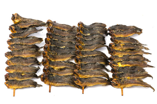 Dried clarias fishes in bamboo skewer