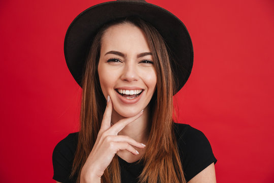 Close up of a happy stylish girl wearing hat laughing