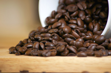 Coffee beans spilling out of cup