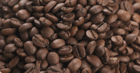 closeup coffee beans falling into bowl