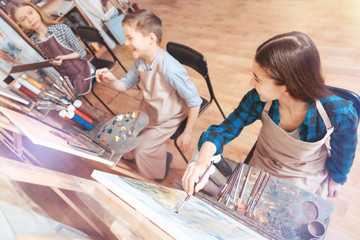 Young wild and talented. Talented teenagers having fun while sitting at their easels and taking part in a painting class all together.