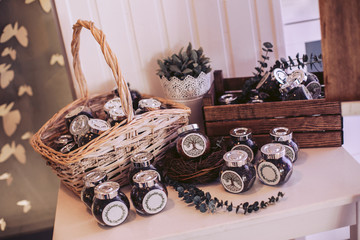 Wicker basket and box with glass jars with filling