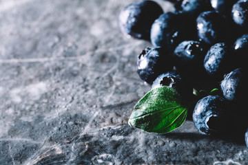 Fresh juicy blueberries and a green leaf