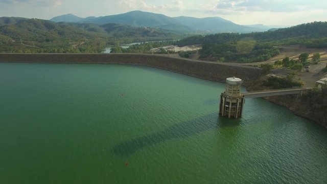 Forward flight toward Lake Eildon Dam among beautiful scenery at sunset. Victoria, Australia