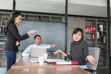 Unhappy Boss scolding young frustrated intern. Setup studio shooting.