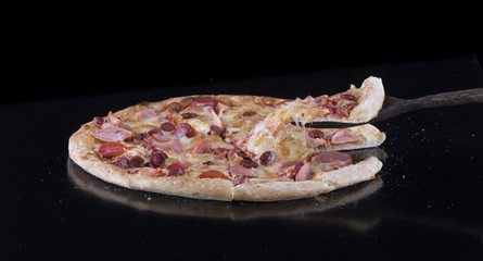 hot pizza on a black isolated background