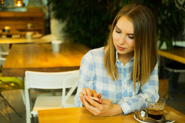 beautiful woman is drinking coffee and reading the morning news 