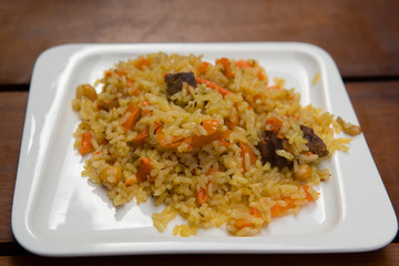 Pilaf of rice with beaf close-up on the plate