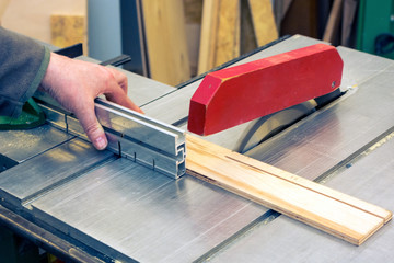 Men cutting wood with circular saw