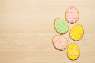 Easter cookies in the form of eggs on a wooden background
