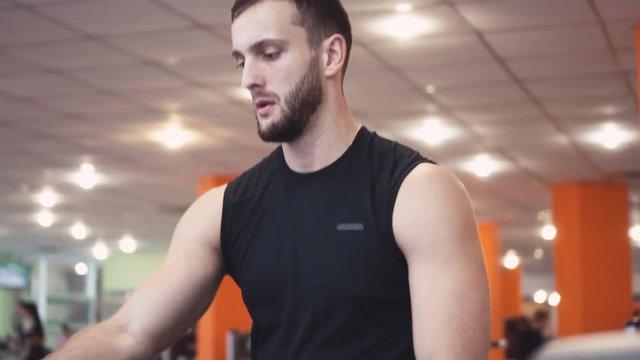 Sportive young man running at gym