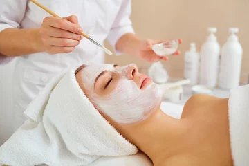 Fotobehang Woman in mask on face in spa beauty salon. © Studio Romantic