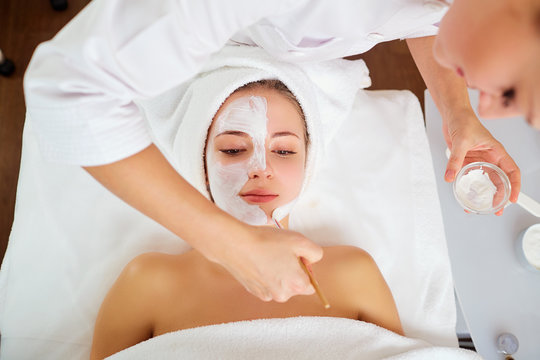 Woman in mask on face in spa beauty salon.