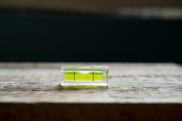 small building level lies on a wooden surface