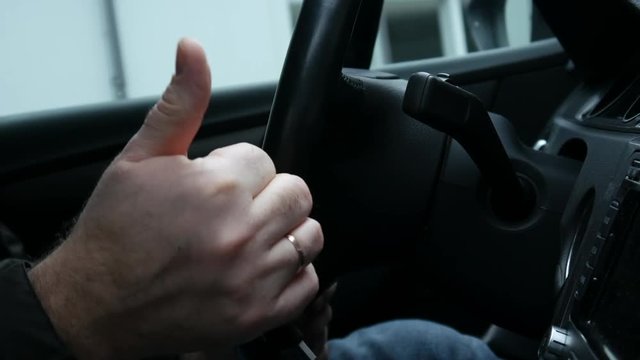 The driver turns off the engine and shows the OK, close-up