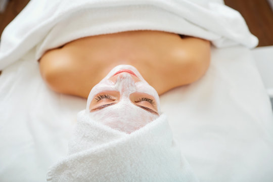 Woman In Mask On Face In Spa Beauty Salon.