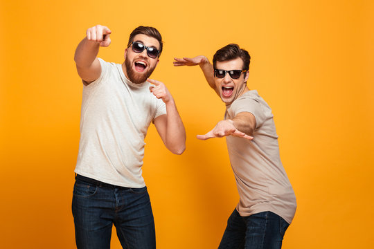 Portrait of a two joyful young men in sunglasses