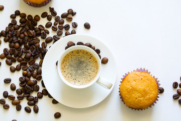 Cup of espresso with muffins and coffee beans on white table. Top view