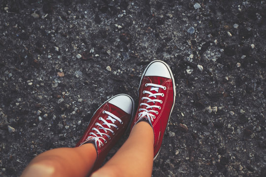 Cheerful young woman sexy legs and red shoes