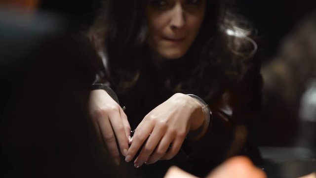 Female felon in handcuffs seduces detective to escape punishment, interrogation