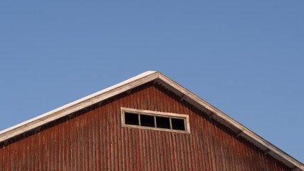 Wooden barn roof and blue sky