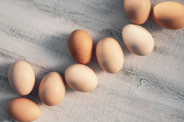 Easter eggs of natural color on a white wooden background. Rutsik style