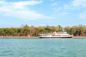 Daylight view to blue water and parked tourist ship