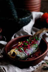 Grilled trout with pomegranate sauce.style rustic