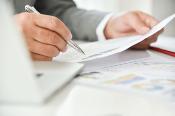 Businessman is pointing on business chart.