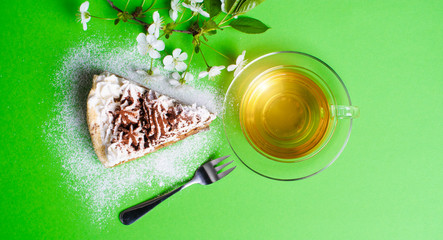 cake with tea on green background