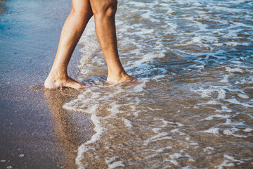 Woman walking on the sea beach