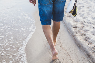 Man walks on the sea beach