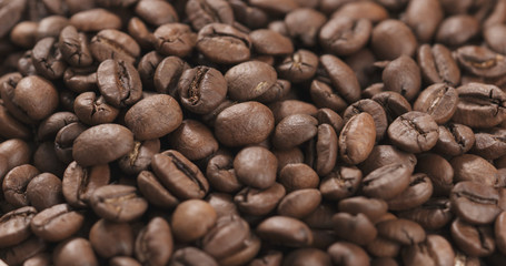 closeup coffee beans falling into bowl